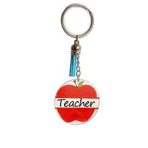 Detail view of acrylic apple pendant with Teacher print and light blue leather tassel