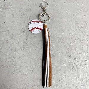 Detail view of retro baseball keychain featuring colorful tassels and silver ring
