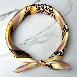 Silky fashion scarf featuring leopard print and sunflower patterns on marble background