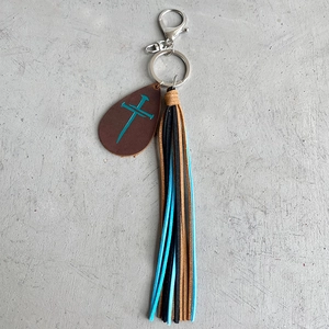 Close-up of a crazy horse leather teardrop keychain with colorful tassels and a cross