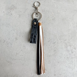 Close-up of multicolored leather tassels with silver rivet and metal lobster clasp detail