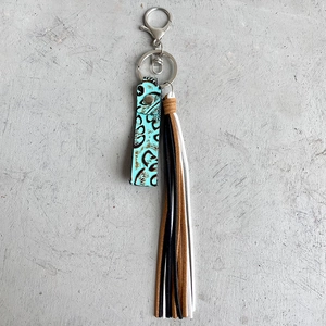 Vintage brown embossed leather keychain with colorful tassels and a silver spring clip