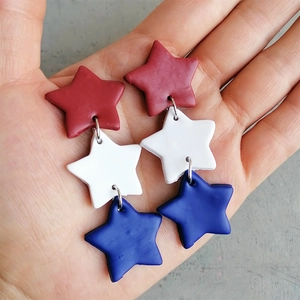 Three-tier red white and blue star-shaped earrings made of matte polymer clay