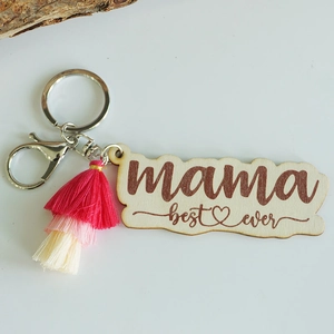 Macro detail of wooden Mother's Day keychain with mama best ever text and pink tassel