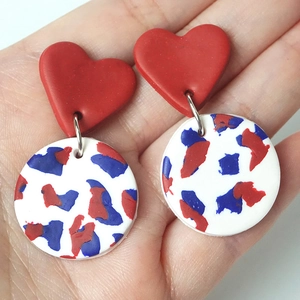 Handmade July 4th polymer clay heart earrings with abstract red and blue patterns