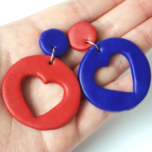 Detail of handmade heart-shaped earrings in red and blue polymer clay for Independence Day