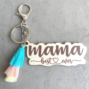 Macro shot of laser-engraved wood keychain with mama best ever text and colorful tassel
