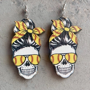 Skull earrings with messy bun and yellow baseball patterns on wood texture background