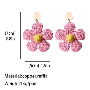 Pink bohemian raffia flower earrings with yellow center and copper hooks for summer
