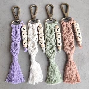 Detail of colorful handmade macrame tassel keychains featuring wood beads with MAMA letters