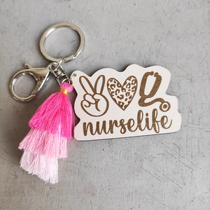 Close-up of nurse life keychain with leopard heart charm and pink gradient tassels