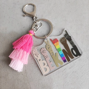 Acrylic Be Kind rainbow keychain with multi-layered pink gradient tassel and silver clasp