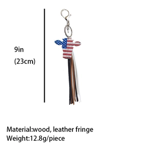 Detail view of American flag pattern bull head keychain with leather tassels and size scale