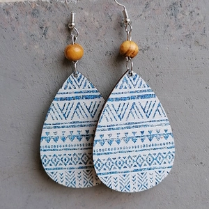 Detail of bohemian teardrop earrings featuring blue geometric patterns and yellow beads