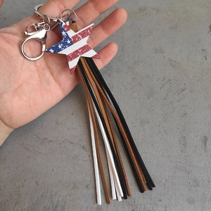 Star-shaped American flag keychain with long colorful tassels and a metal ring