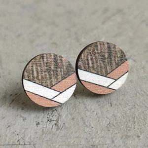 Detailed macro view of bohemian geometric round wooden earrings with colorful striped texture
