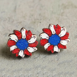 Macro shot of wooden sunflower studs featuring American flag colors on a rustic base