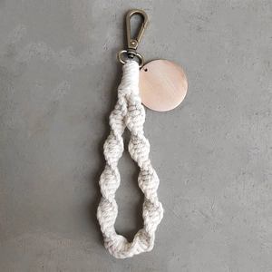 Handmade Macrame wristlet keychain with natural wood disc and gold metal clasp