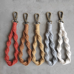 Flat lay of five colorful macrame keychains with vintage bronze metal lobster clasps