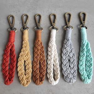 Close-up of six colorful hand-woven macrame keychains with bronze metal lobster clasps