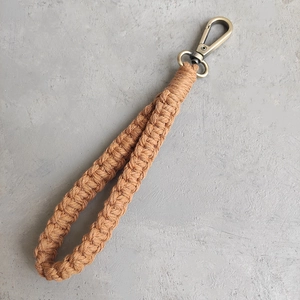 Détail d'un porte-clés bohème tissé à la main avec fermoir mousqueton en bronze vintage