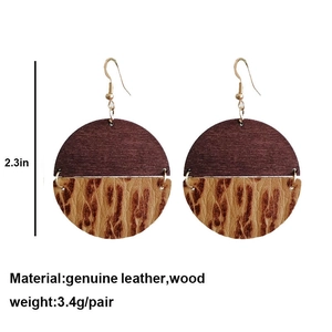 Detail view of large round wood and leopard leather earrings with size and weight specs