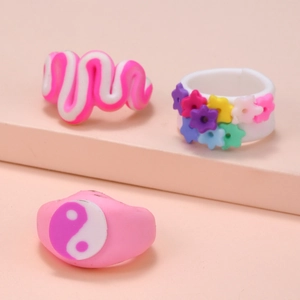 Detailed view of colorful Y2K resin rings with floral and yin yang patterns on steps