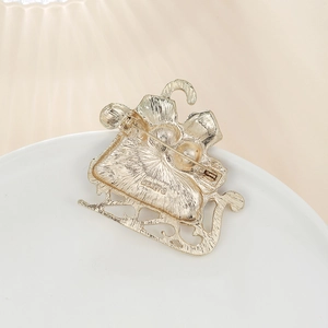 Macro shot of the detailed vintage gold sleigh brooch back with Monet brand stamp