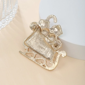 Detail of gold-plated Christmas sleigh brooch back showing pin clasp and Monet branding