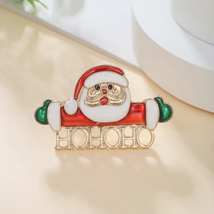 Detail of Santa Claus Christmas brooch with HOHOHO lettering in red and green enamel