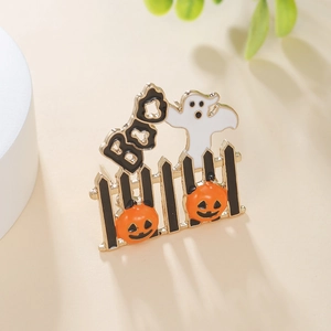 Close-up of Halloween enamel brooch with pumpkin, ghost, and BOO text detail
