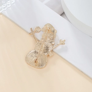 Detailed back view of Christmas gold brooch showing secure safety pin and alloy texture