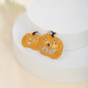Macro shot of a pumpkin brooch with orange enamel finish and sparkling rhinestones