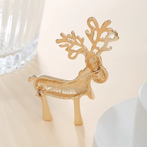 Detailed back view of a golden reindeer brooch showing secure pin closure and metal texture