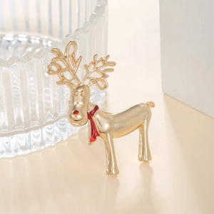 Close-up of golden reindeer brooch with red oil-dripped scarf and frosted metal texture