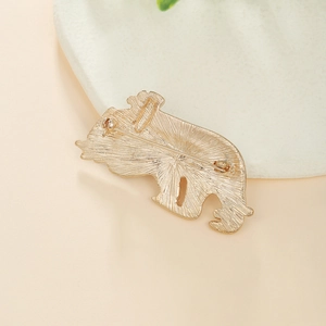 Detailed back view of a gold koala brooch featuring textured metal and safety pin clasp