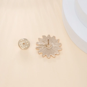 Detailed back view of gold flower brooch showing textured petals and clasp pin