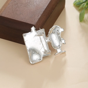 Macro detail of Snoopy house brooch silver back showing S925 stamp and safety pin clasp