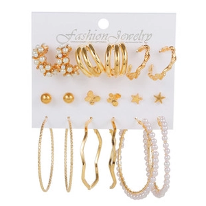 Set of nine gold-finish earring pairs featuring pearls, stars, and butterflies on card