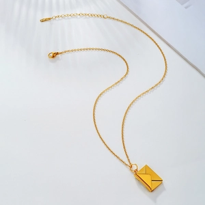 Detailed view of golden envelope locket necklace with S-STEEL tag and lobster clasp