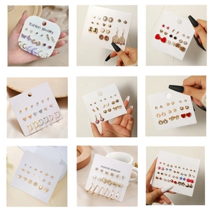 Variety set of fashion stud earrings with butterfly and star designs on display cards
