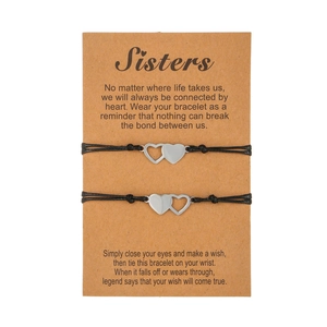 Set of two matching heart sisters wish bracelets on a sentimental message gift card