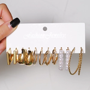 Detail view of 6 pairs vintage gold earring set with hoops and pearls on display card