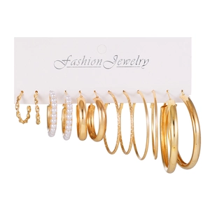 Detailed close-up of 6 pairs of gold hoop earrings with twisted and pearl accents