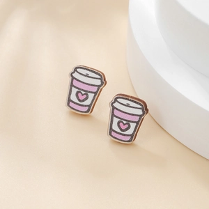 Close-up of wooden coffee cup earrings with pink stripes and heart pattern for Easter