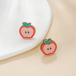 Detailed view of apple-shaped wooden stud earrings with cute cartoon fruit design