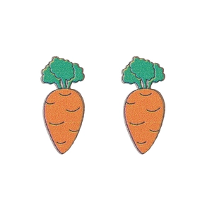 Detailed view of carrot-shaped wooden earrings with glitter finish for Easter fashion