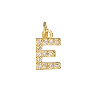 Macro detail of 18k gold plated letter E pendant micro-paved with sparkling zircon stones
