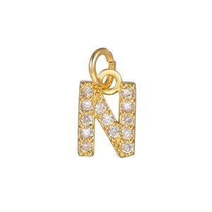 Macro detail of gold plated letter N pendant with micro-paved white cubic zirconia stones