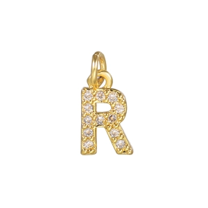 Macro view of 14k gold plated letter R pendant with micro-pave cubic zirconia stones